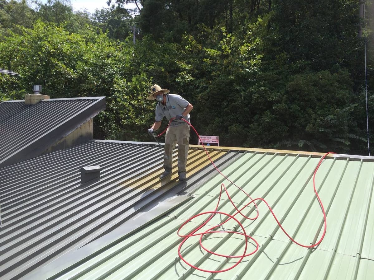 Metal roof spray painting in progress – Skyways Roofing