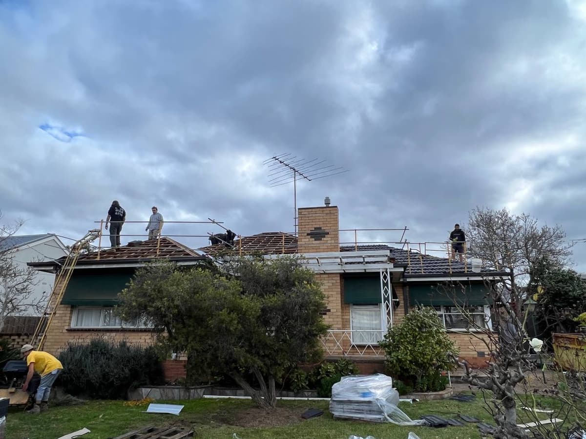 Re-roofing team at work with gutter removal – Skyways Roofing