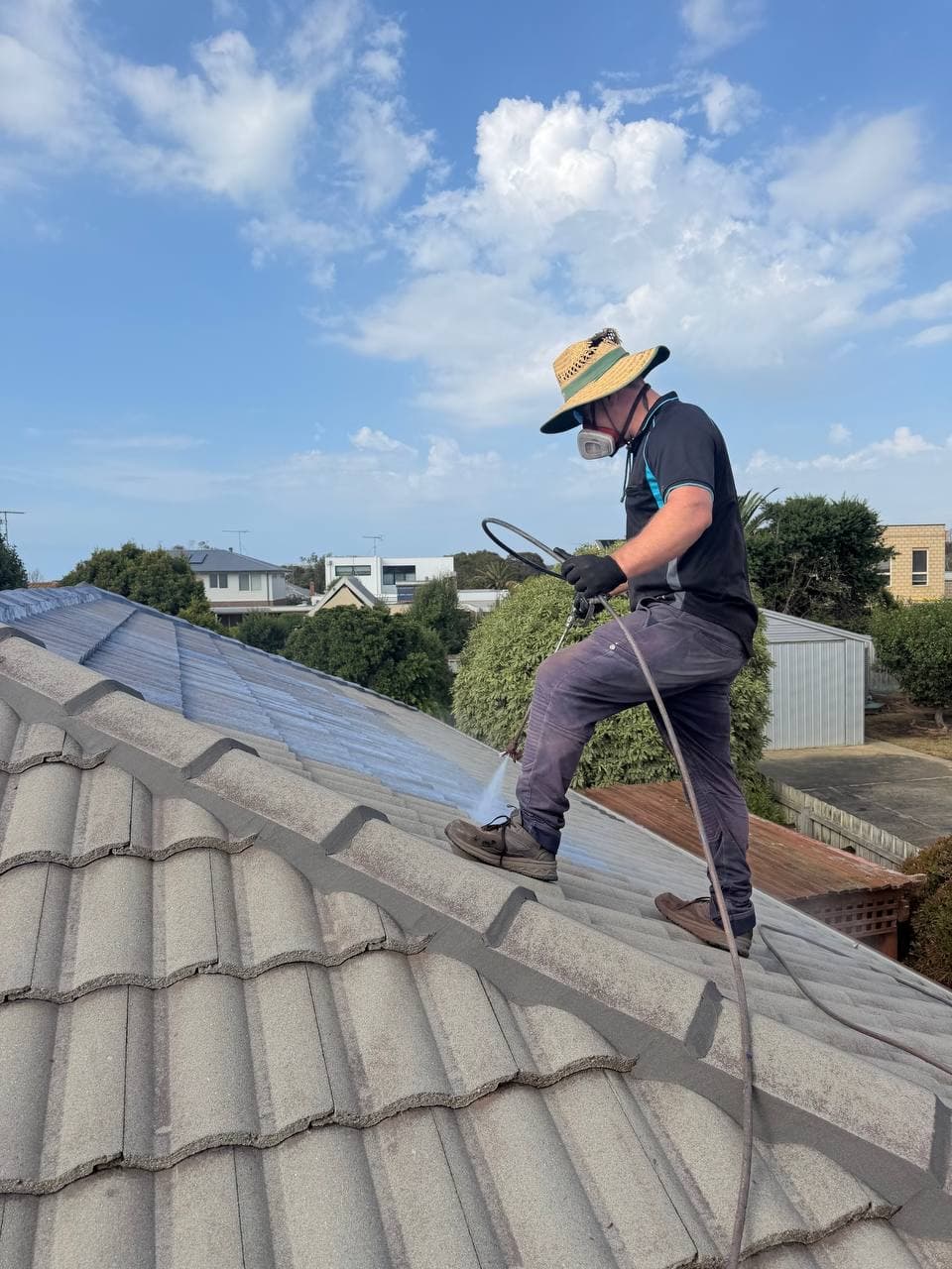 Roofer applying sealant to tile roof – Skyways Roofing